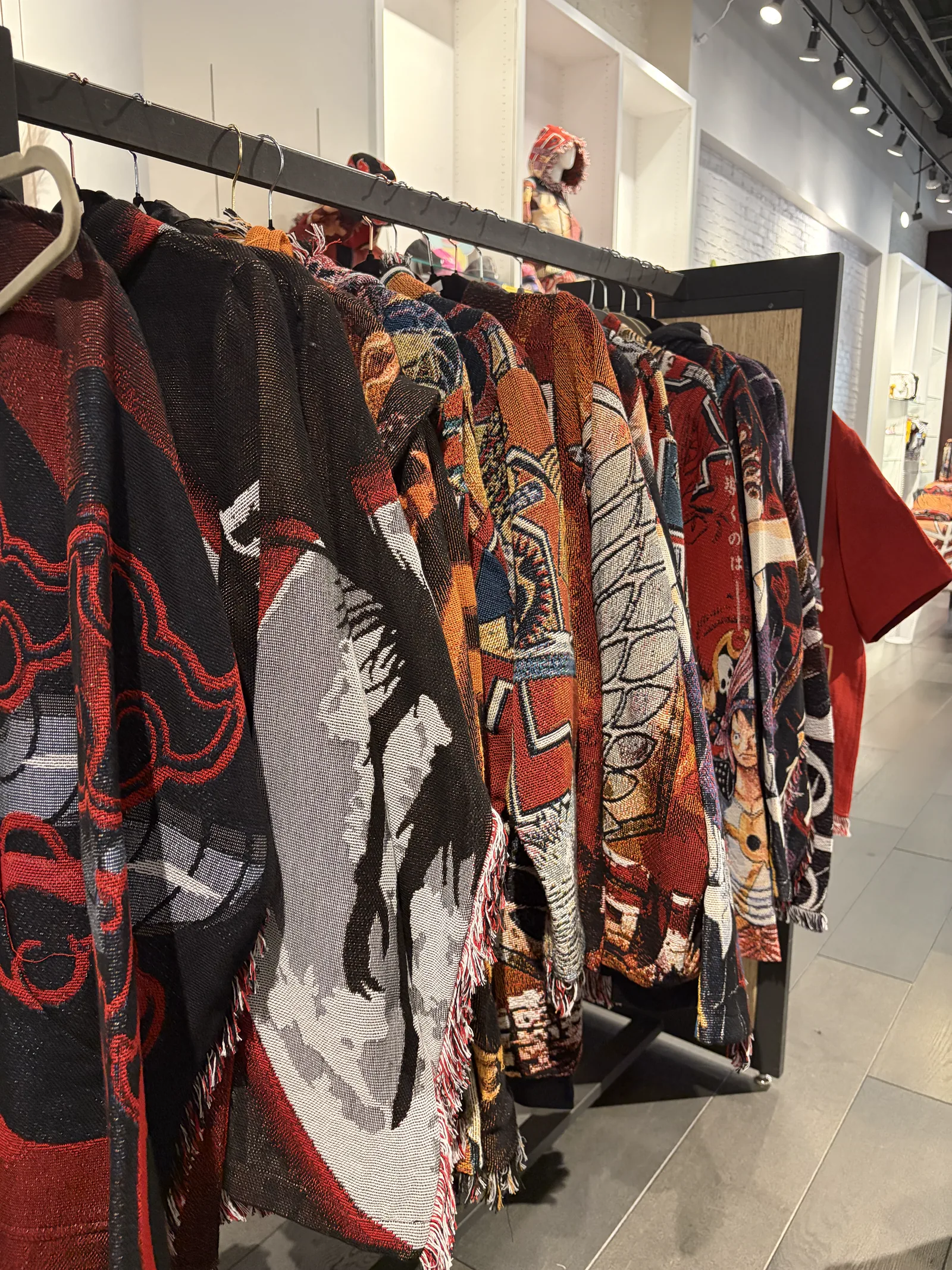 Colorful woven apparel displayed inside a Noah Creations retail location